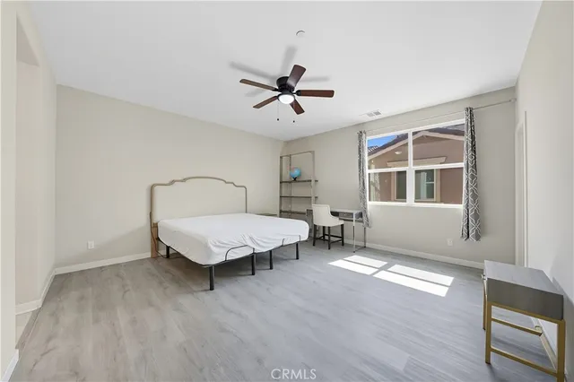 a living room with a bed furniture and a window