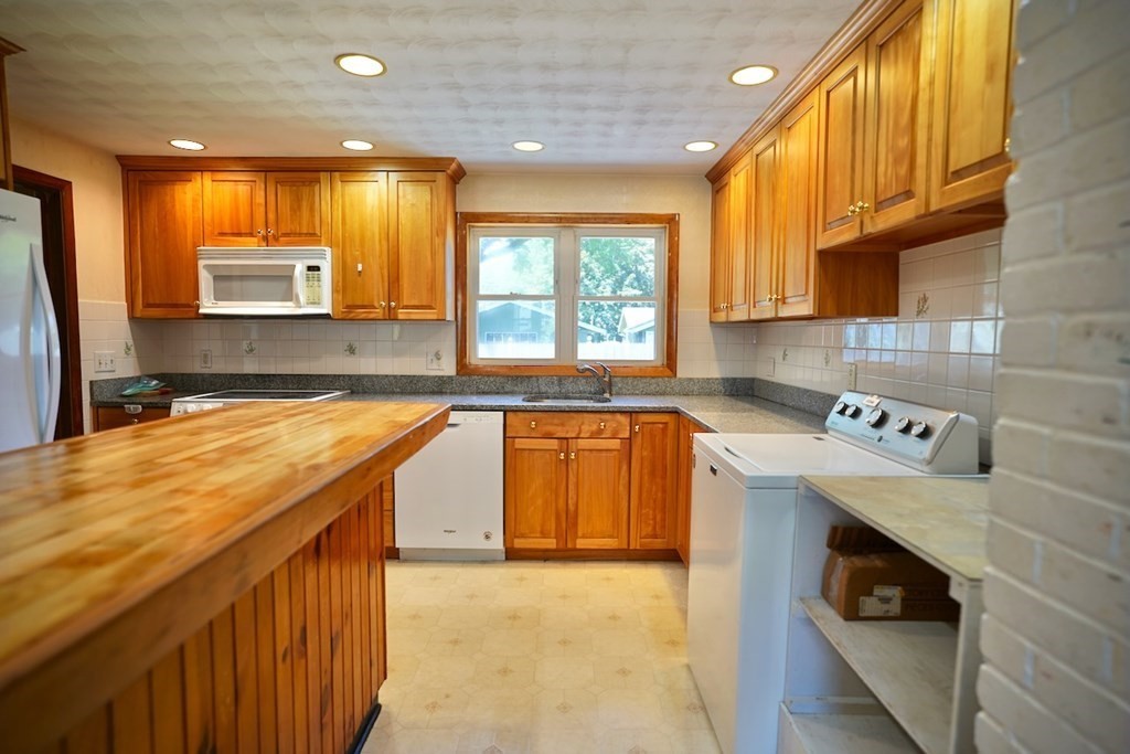 8 Dondi Road Beverly, MA 01915 - Photo 12 of 29 a kitchen with a stove a sink and a microwave