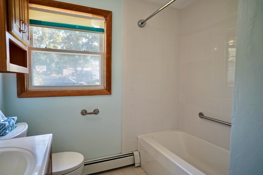 8 Dondi Road Beverly, MA 01915 - Photo 23 of 29 a white toilet sitting next to a bath tub