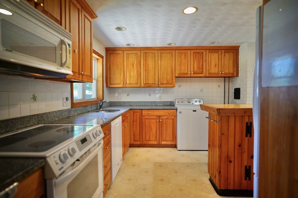 8 Dondi Road Beverly, MA 01915 - Photo 6 of 29 a kitchen with stainless steel appliances granite countertop a stove a sink and a microwave