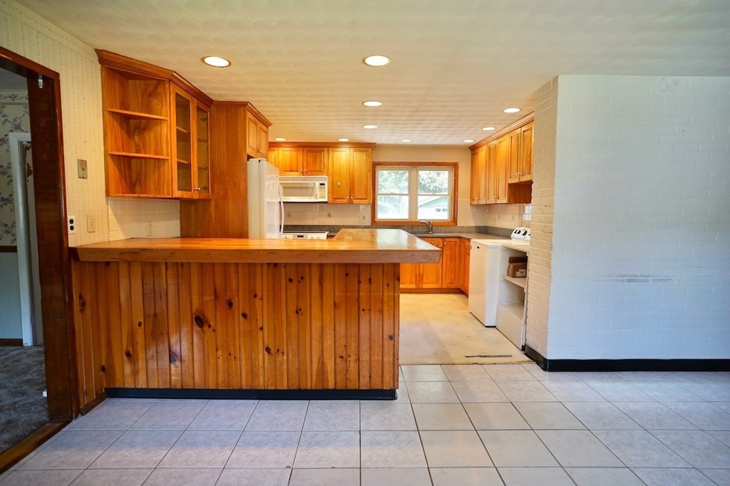 8 Dondi Road Beverly, MA 01915 - Photo 10 of 29 a kitchen with stainless steel appliances a sink a stove a refrigerator cabinets and a window
