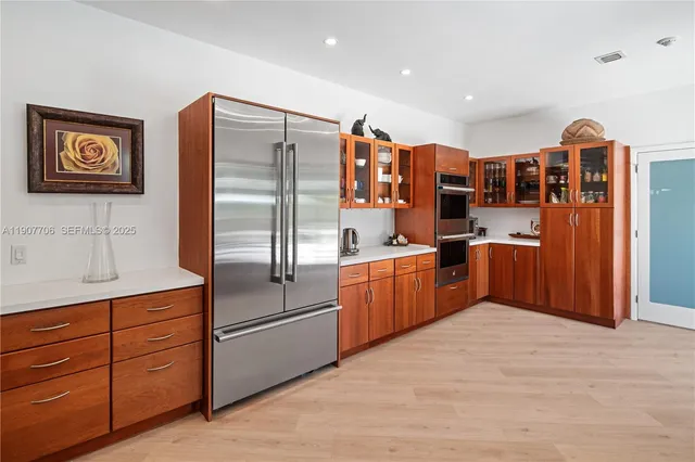a kitchen with stainless steel appliances granite countertop a refrigerator and a sink