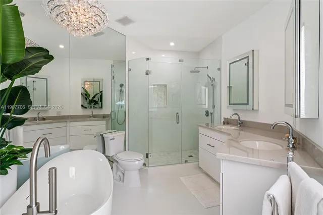a bathroom with a granite countertop sink a mirror and shower