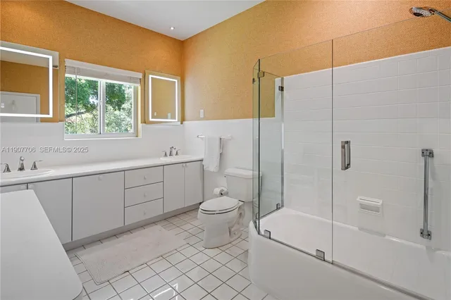 a bathroom with a toilet sink and shower