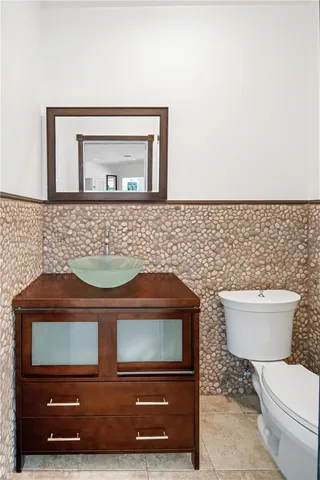 a bathroom with a toilet a sink and a mirror