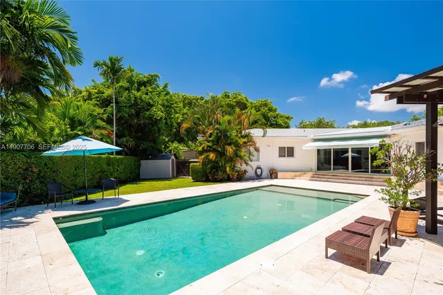 a view of a house with a yard porch and sitting area
