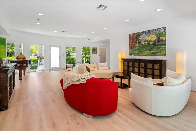a living room with furniture and a large window