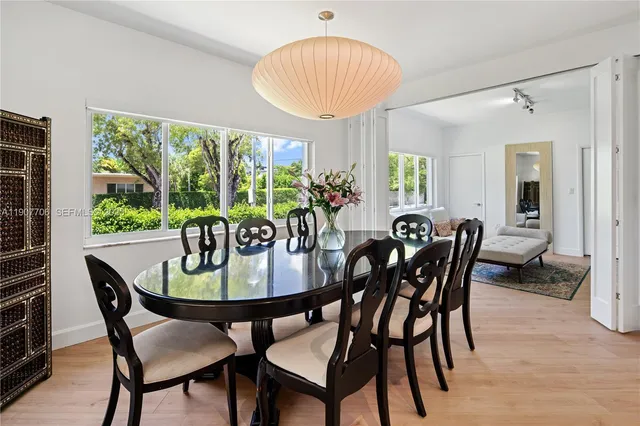 a view of a dining room with furniture and a potted plant