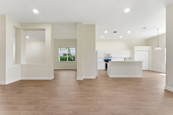 a kitchen with kitchen island granite countertop a sink a center island stainless steel appliances and cabinets