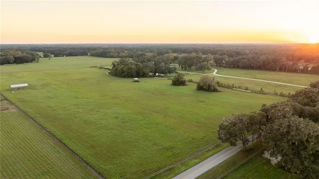a view of a field with an ocean view