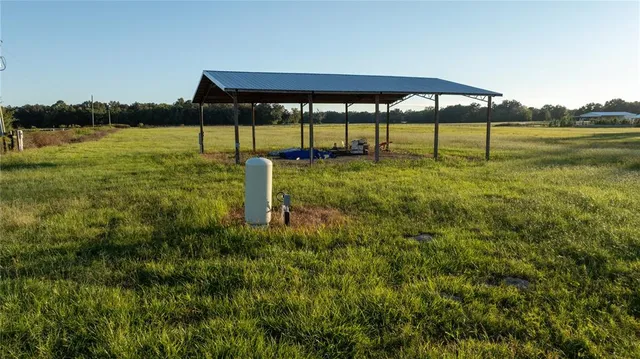 a view of a big yard with table and chairs