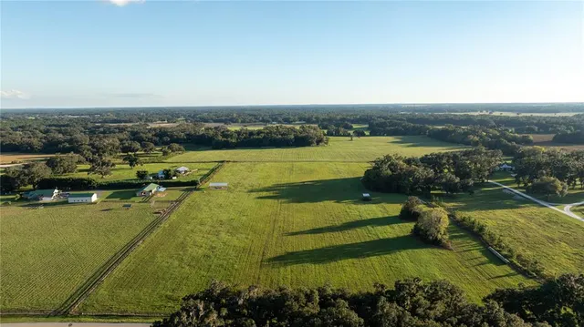 an aerial view of a houses with a lake view
