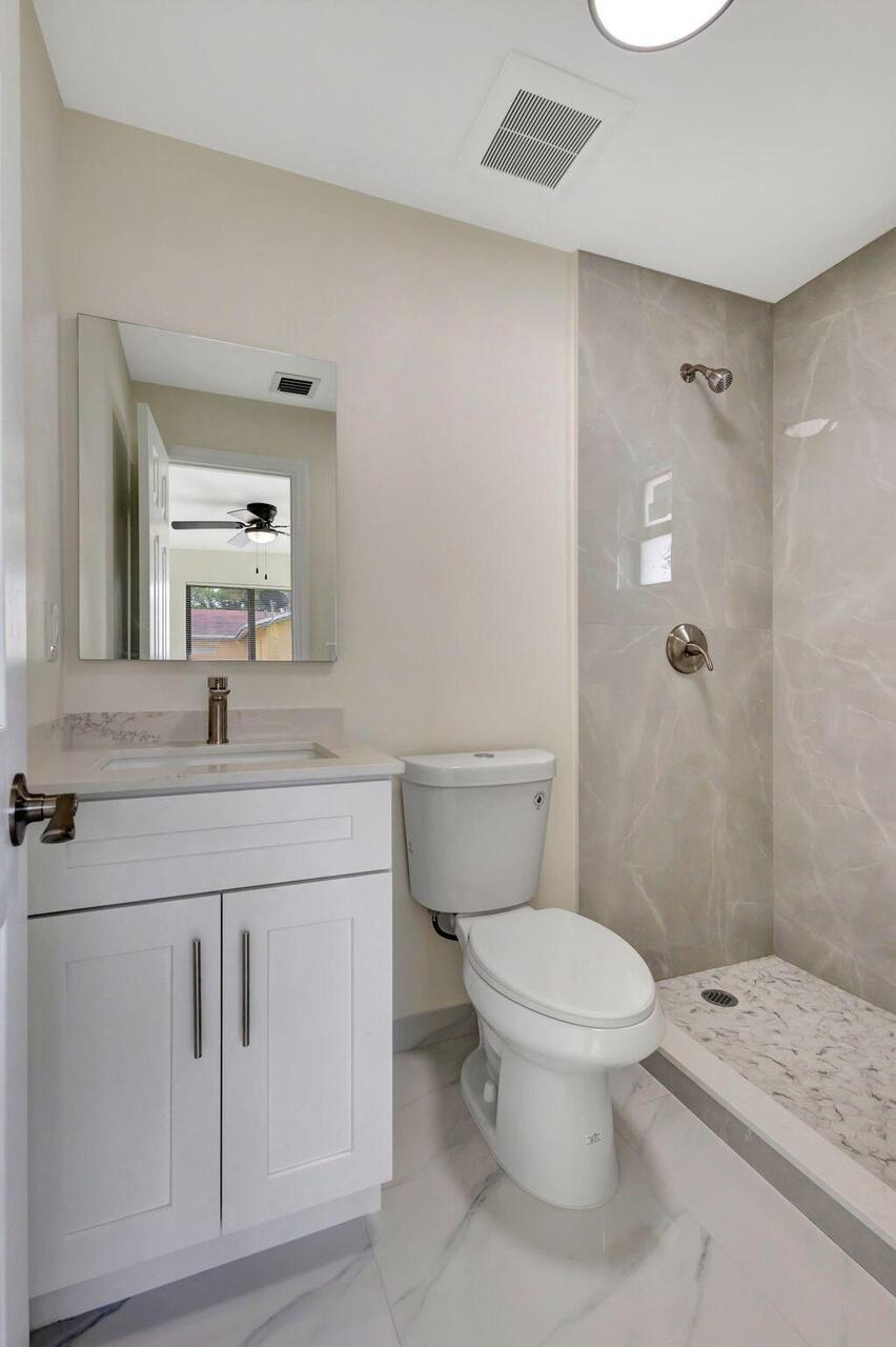2016 Avenue South Riviera Beach, FL 33404 - Photo 4 of 17 a bathroom with a sink a toilet and shower