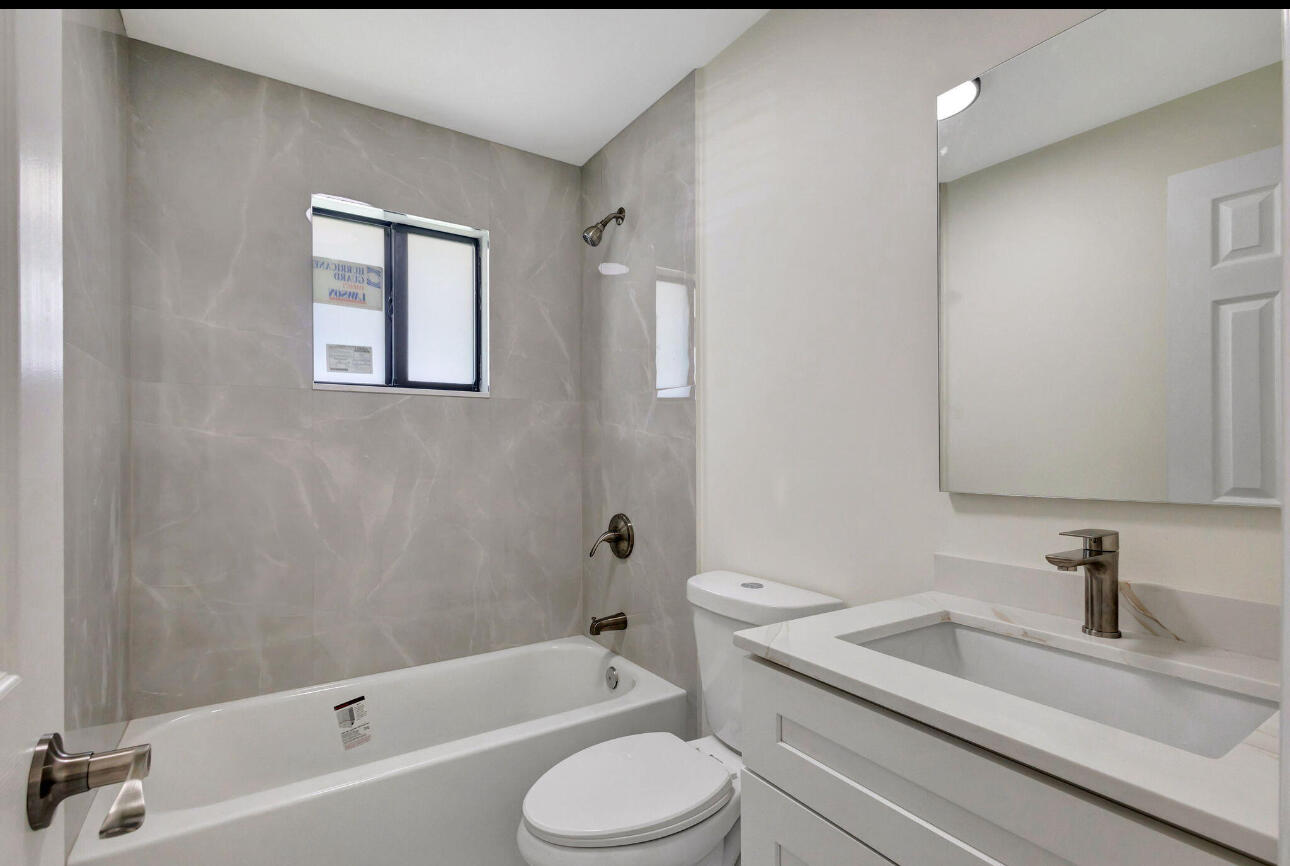2016 Avenue South Riviera Beach, FL 33404 - Photo 8 of 17 a bathroom with a sink toilet and bathtub