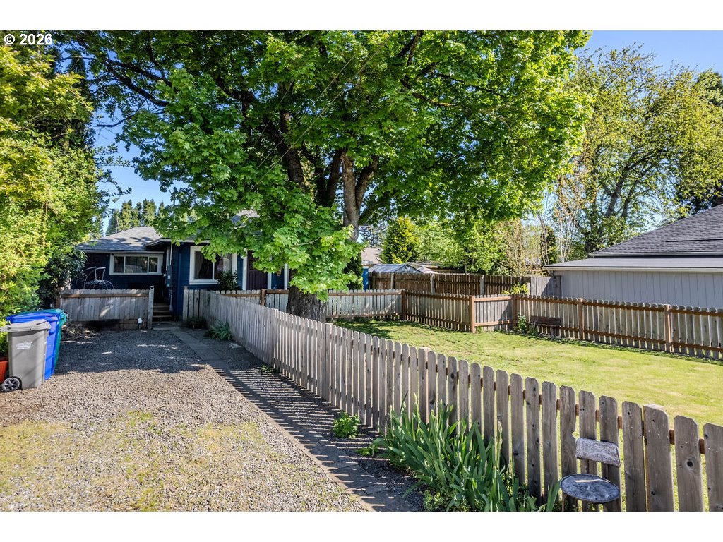 105 Northwest 13th Street Gresham, OR 97030 - Photo 3 of 45 a view of a backyard with wooden fence and a bench