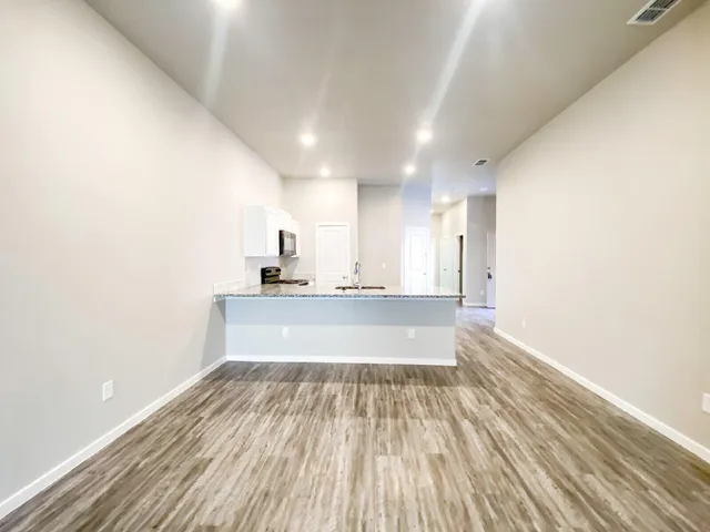 a view of kitchen with sink and refrigerator