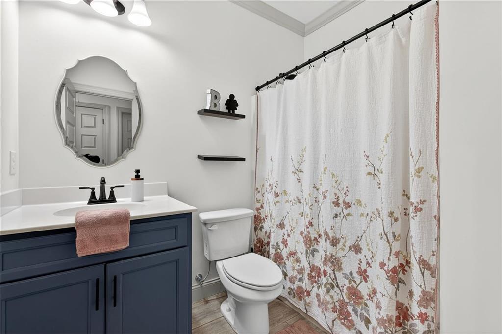 4 Tahlequah Street Northeast Rome, GA 30161 - Photo 19 of 52 a bathroom with a toilet sink and mirror