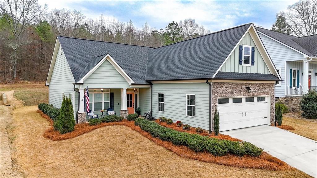 4 Tahlequah Street Northeast Rome, GA 30161 - Photo 2 of 52 a view of a white house with a small yard plants and a large tree