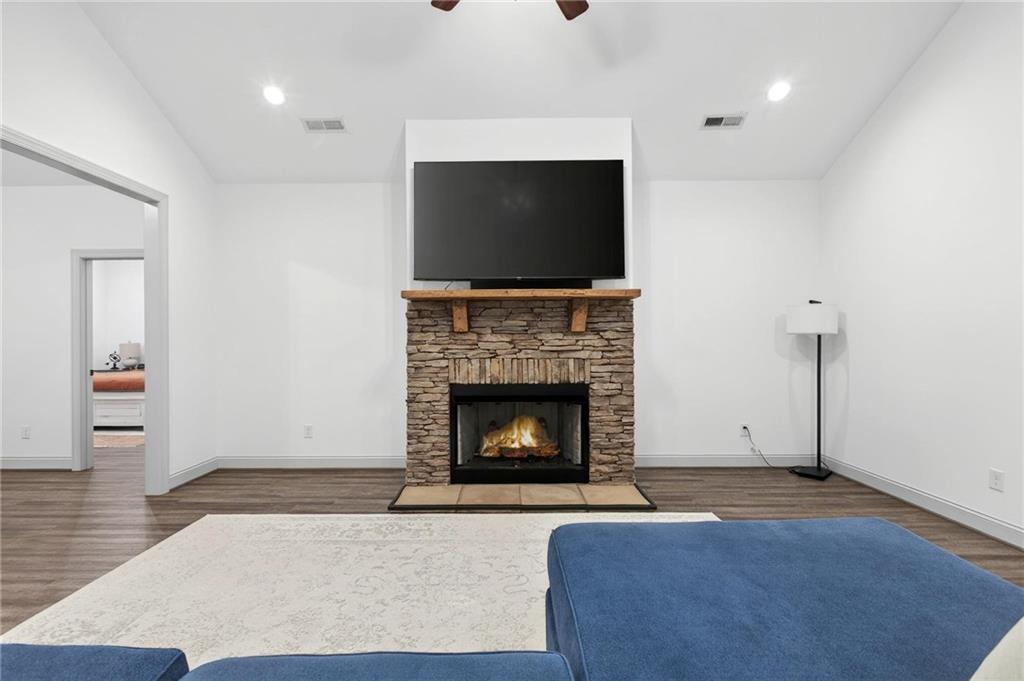 4 Tahlequah Street Northeast Rome, GA 30161 - Photo 24 of 52 a living room with furniture a flat screen tv and a fireplace