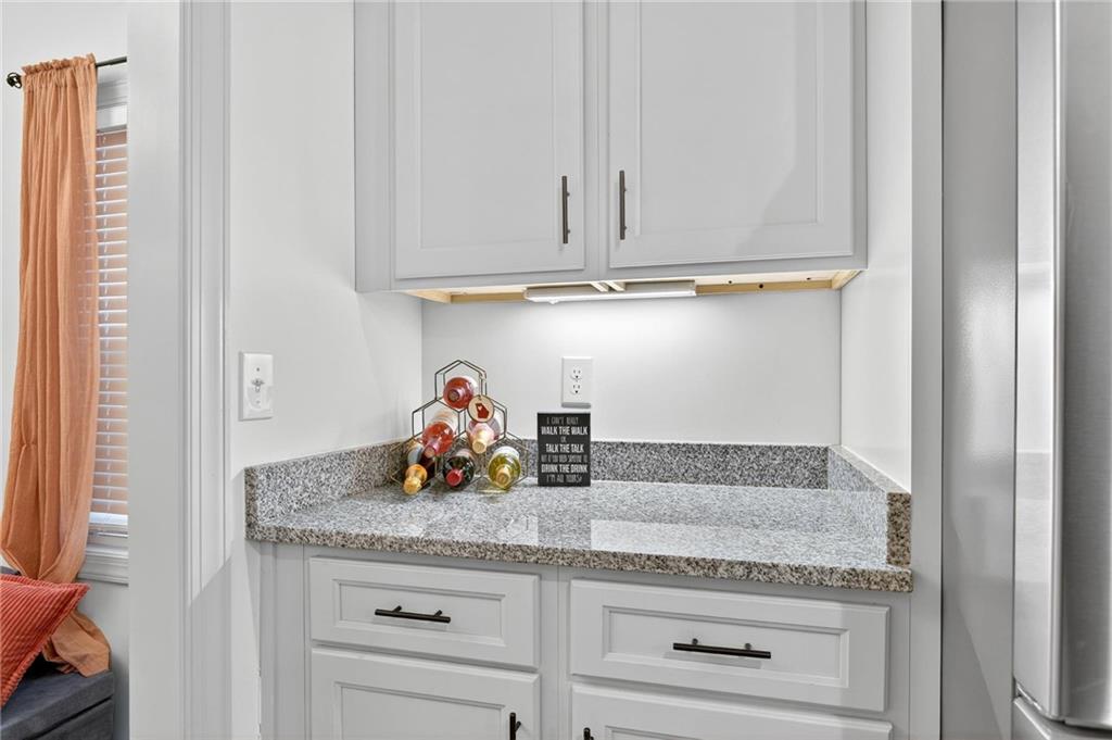 4 Tahlequah Street Northeast Rome, GA 30161 - Photo 31 of 52 a kitchen with granite countertop stainless steel appliances white cabinets and a granite counter tops