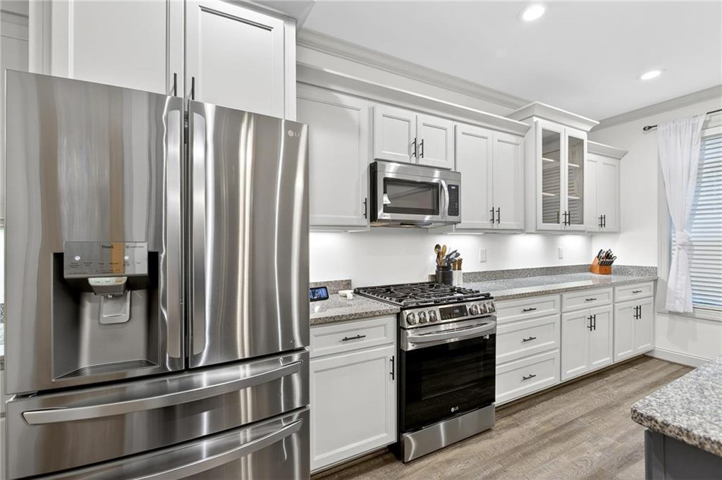 4 Tahlequah Street Northeast Rome, GA 30161 - Photo 32 of 52 a kitchen with kitchen island granite countertop stainless steel appliances and wooden cabinets