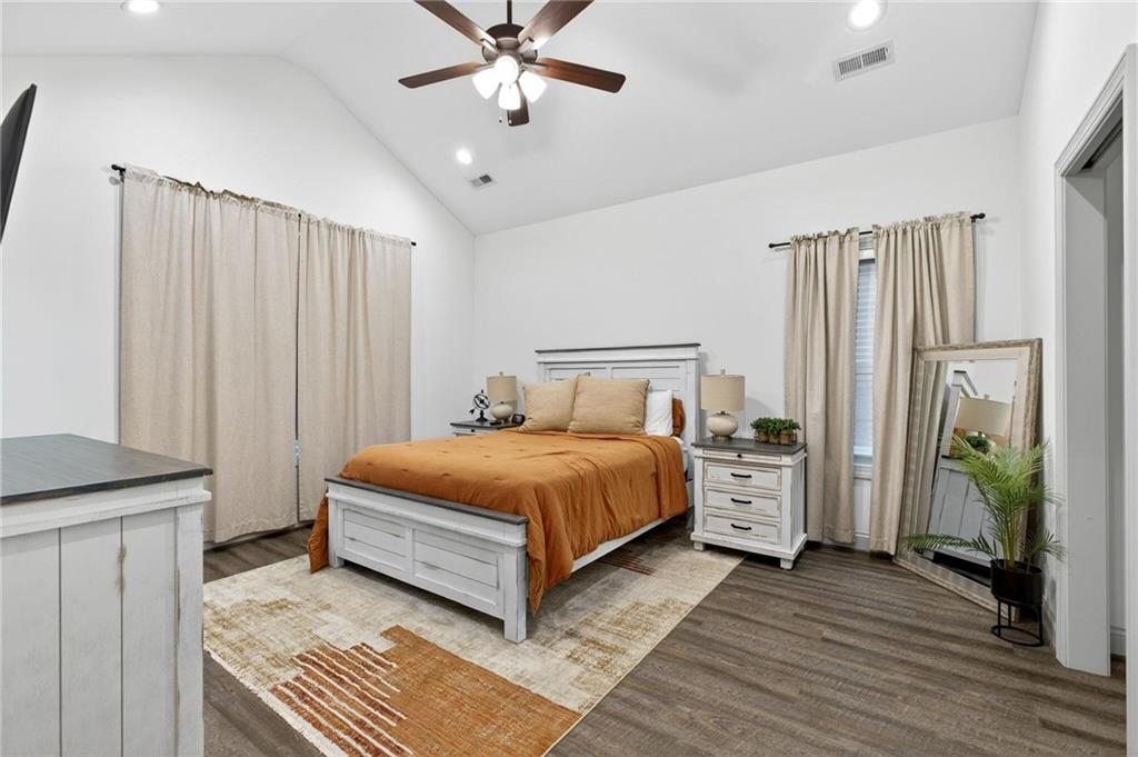 4 Tahlequah Street Northeast Rome, GA 30161 - Photo 35 of 52 a spacious bedroom with a bed and a chandelier