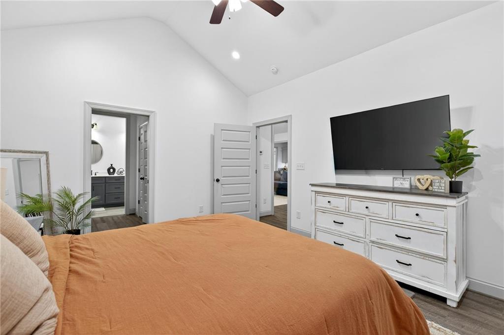 4 Tahlequah Street Northeast Rome, GA 30161 - Photo 37 of 52 a bedroom with a bed a flat screen tv and a potted plant