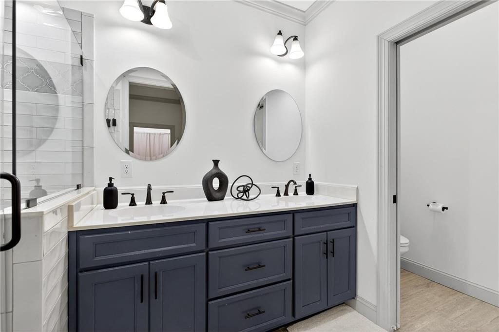 4 Tahlequah Street Northeast Rome, GA 30161 - Photo 39 of 52 a bathroom with a double vanity sink and a mirror
