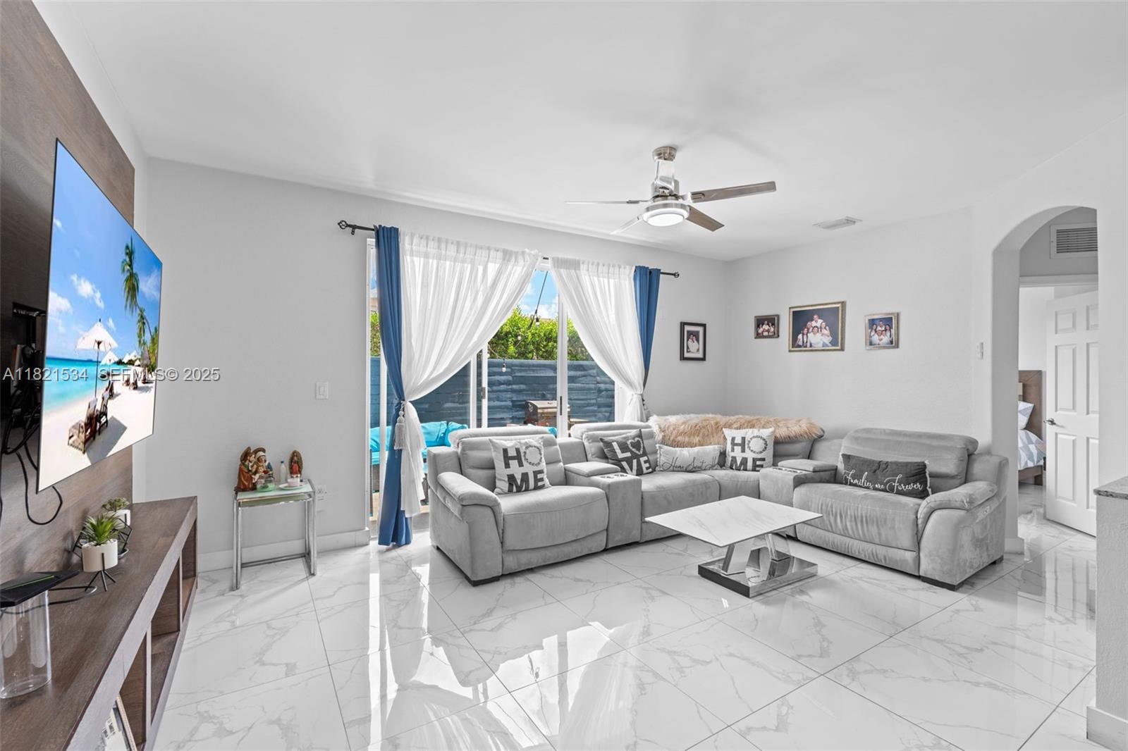 13745 Southwest 113th Lane Miami, FL 33186 - Photo 17 of 53 a living room with furniture a flat screen tv and a large window