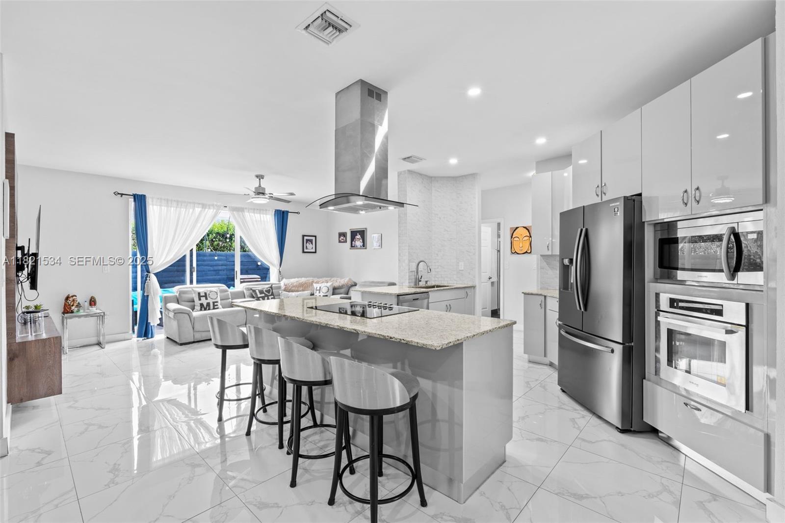 13745 Southwest 113th Lane Miami, FL 33186 - Photo 22 of 53 a kitchen with stainless steel appliances a sink a stove a refrigerator and cabinets