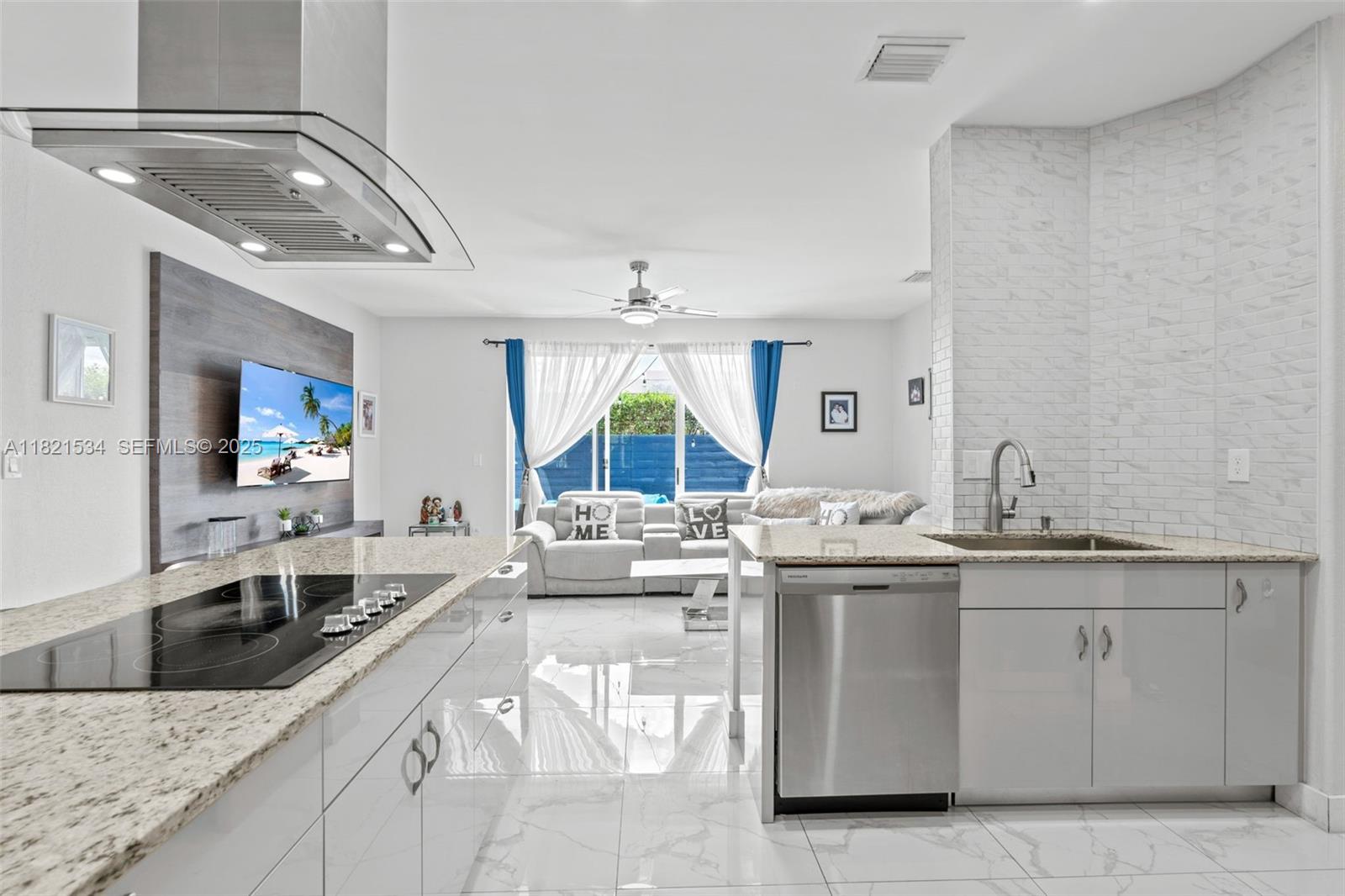 13745 Southwest 113th Lane Miami, FL 33186 - Photo 25 of 53 a large kitchen with a lot of white cabinets and stainless steel appliances