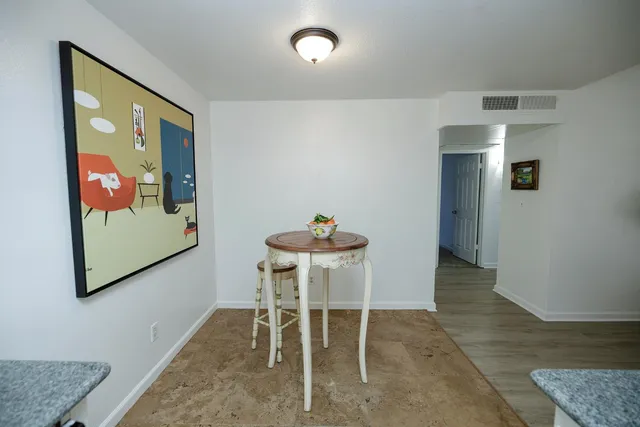 a dining room with furniture and window