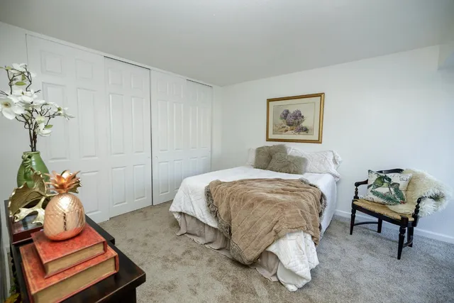 a bedroom with a bed and chair