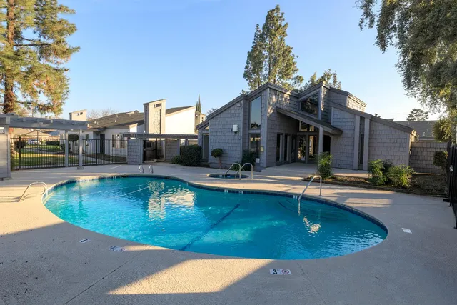 a swimming pool with outdoor seating and yard
