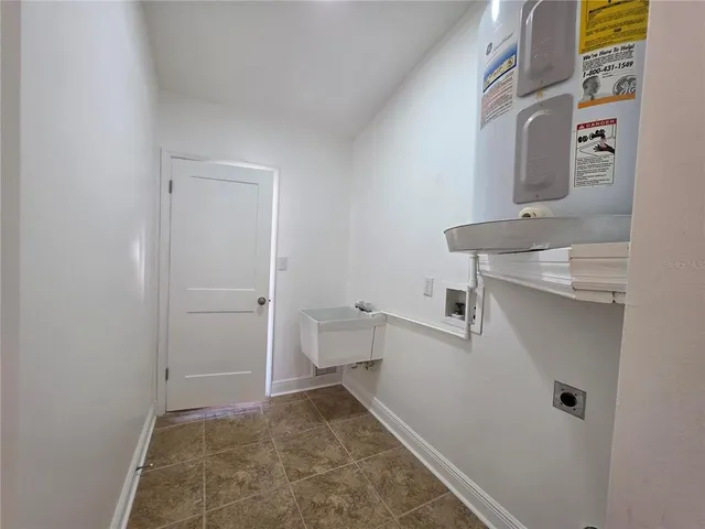 an empty room with a ceiling fan and a window