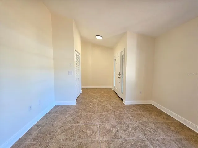 an empty room with windows and closet