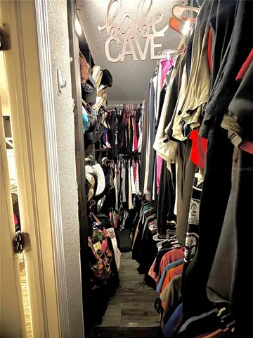 a view of walk in closet with clothes