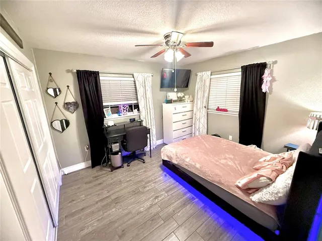 a bedroom with bed and a flat tv screen