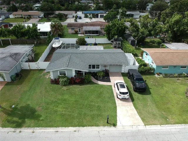an aerial view of a house with swimming pool garden and patio