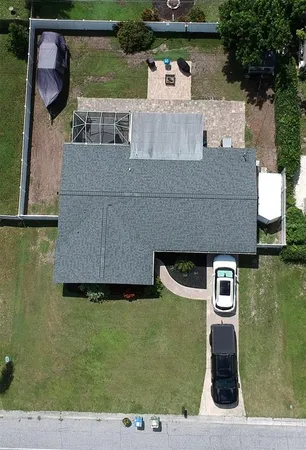 an aerial view of a house with a yard