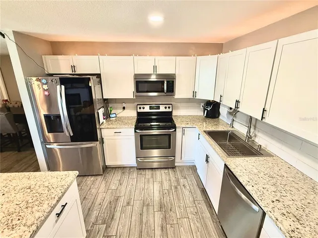 a kitchen with a sink stove and refrigerator