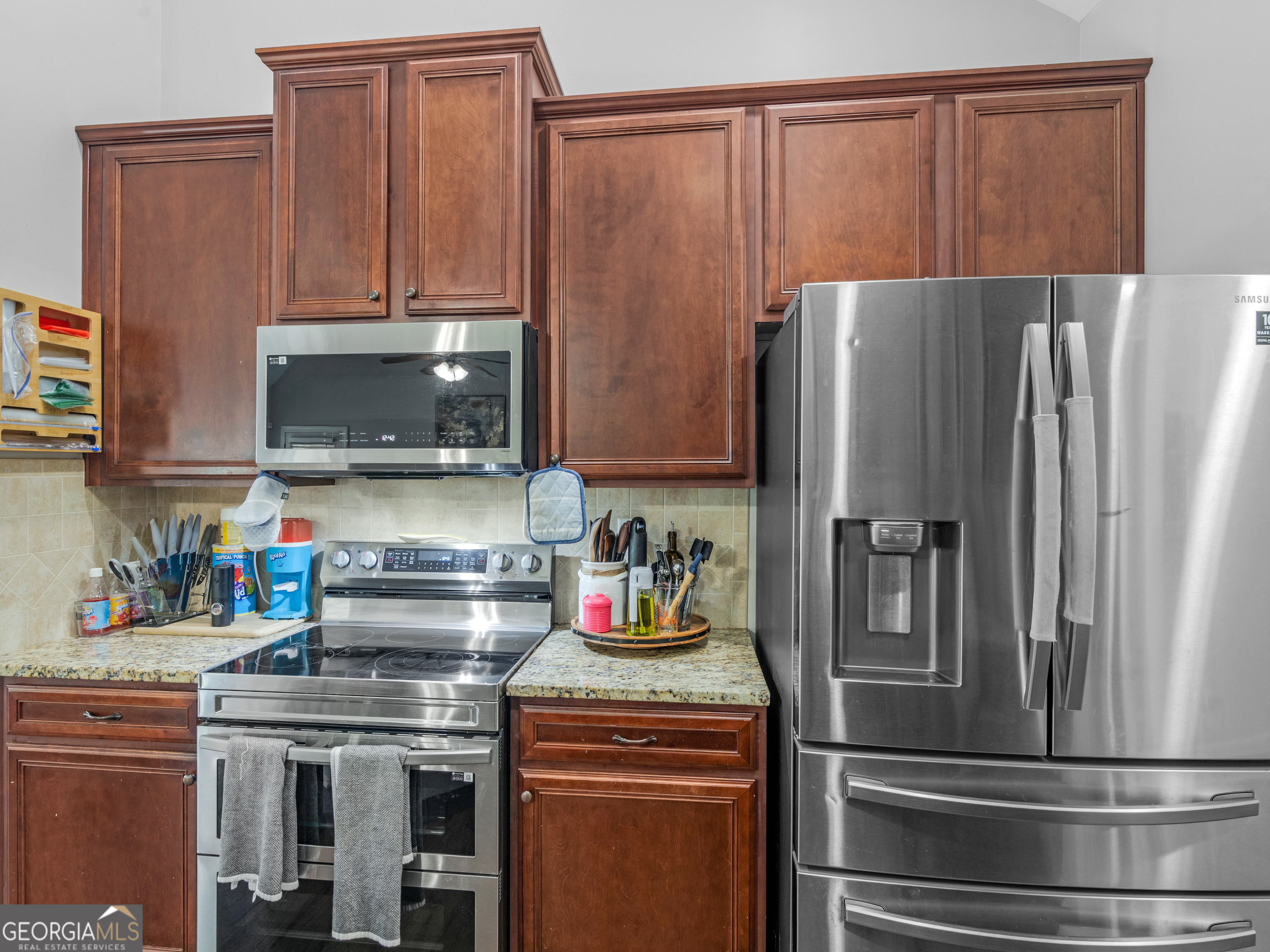 601 Amerigo Court Locust Grove, GA 30248 - Photo 13 of 23 a kitchen with stainless steel appliances granite countertop a refrigerator and a stove top oven