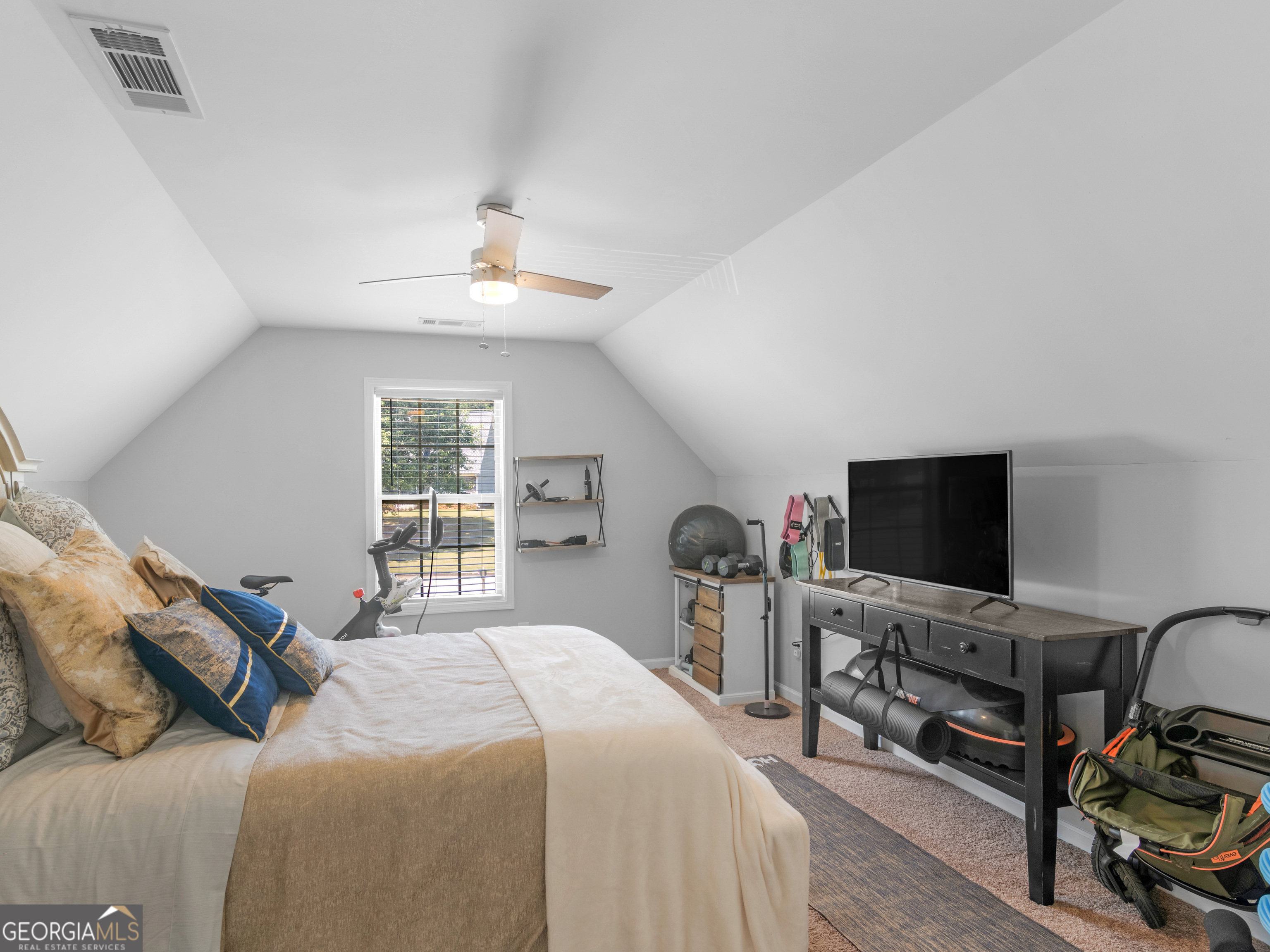 601 Amerigo Court Locust Grove, GA 30248 - Photo 19 of 23 a bedroom with a bed and a flat screen tv