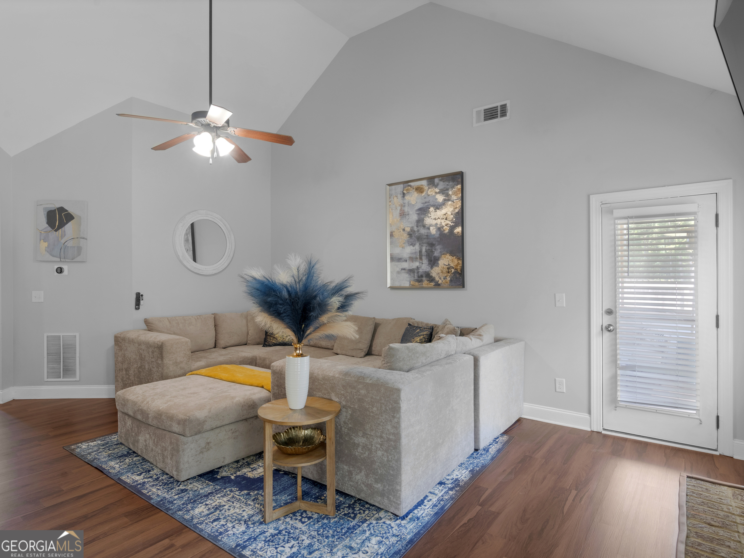 601 Amerigo Court Locust Grove, GA 30248 - Photo 5 of 23 a living room with furniture a wooden floor and a chandelier