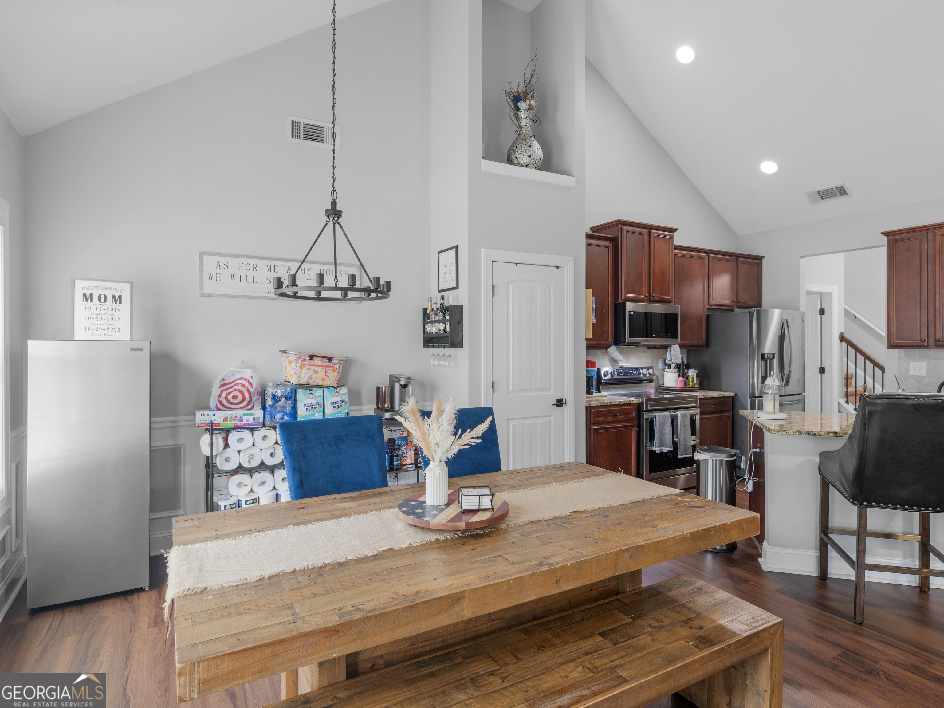 601 Amerigo Court Locust Grove, GA 30248 - Photo 9 of 23 a kitchen with kitchen island stainless steel appliances a stove refrigerator sink and cabinets