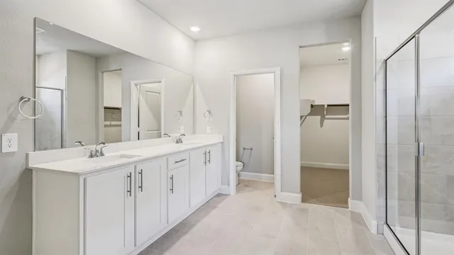 a bathroom with a glass shower door