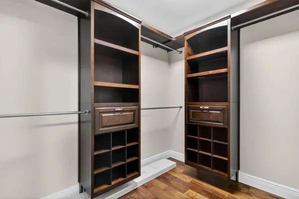 a view of a hallway with white cabinets