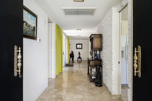 a view of a hallway with living room and furniture
