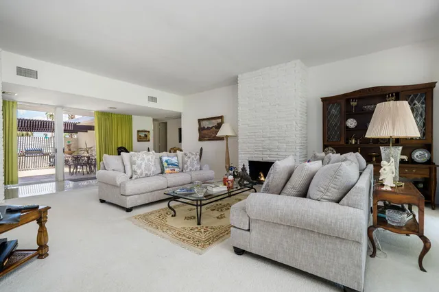 a living room with furniture and a lamp