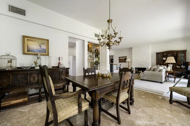 a view of a dining room with furniture and chandelier